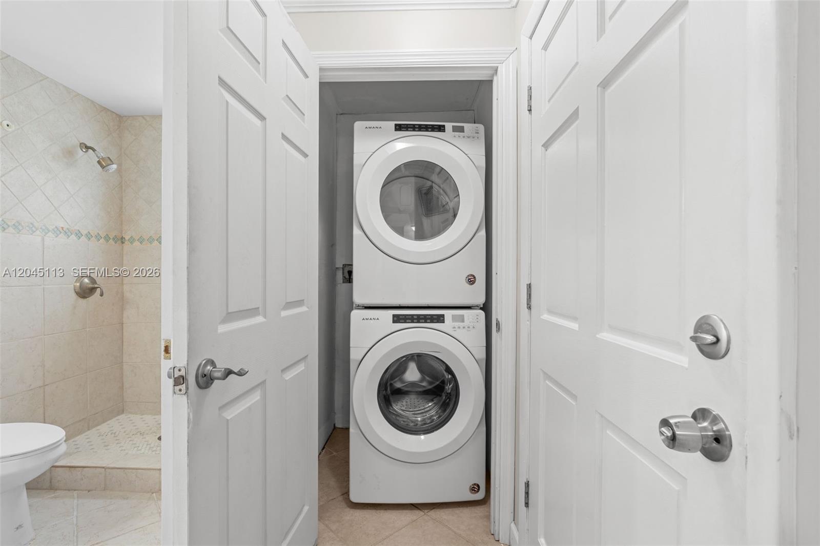 A stacked Amana washer and dryer unit is located in a closet beside a bathroom — 795 NW 73rd Ave, Margate FL 33063, MARGATE, FL