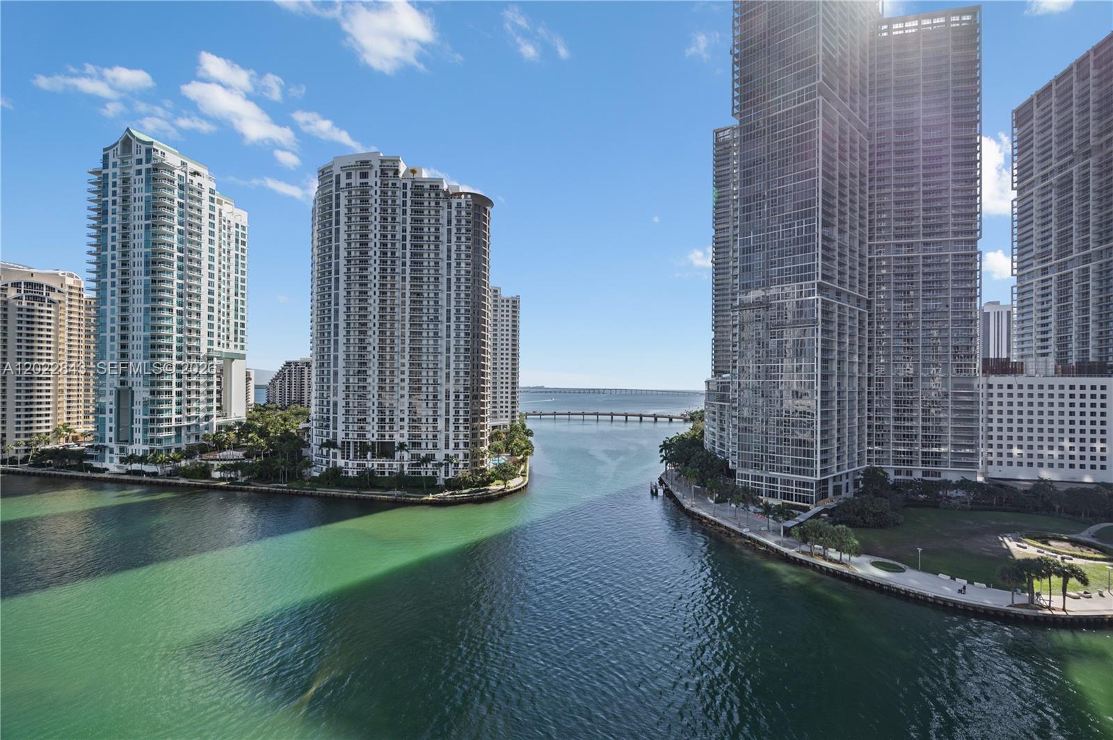 An elevated view of a waterway flowing between tall residential high-rise buildings in Miami — 300 Biscayne Blvd Way # 1102, Miami FL 33131, MIAMI, FL