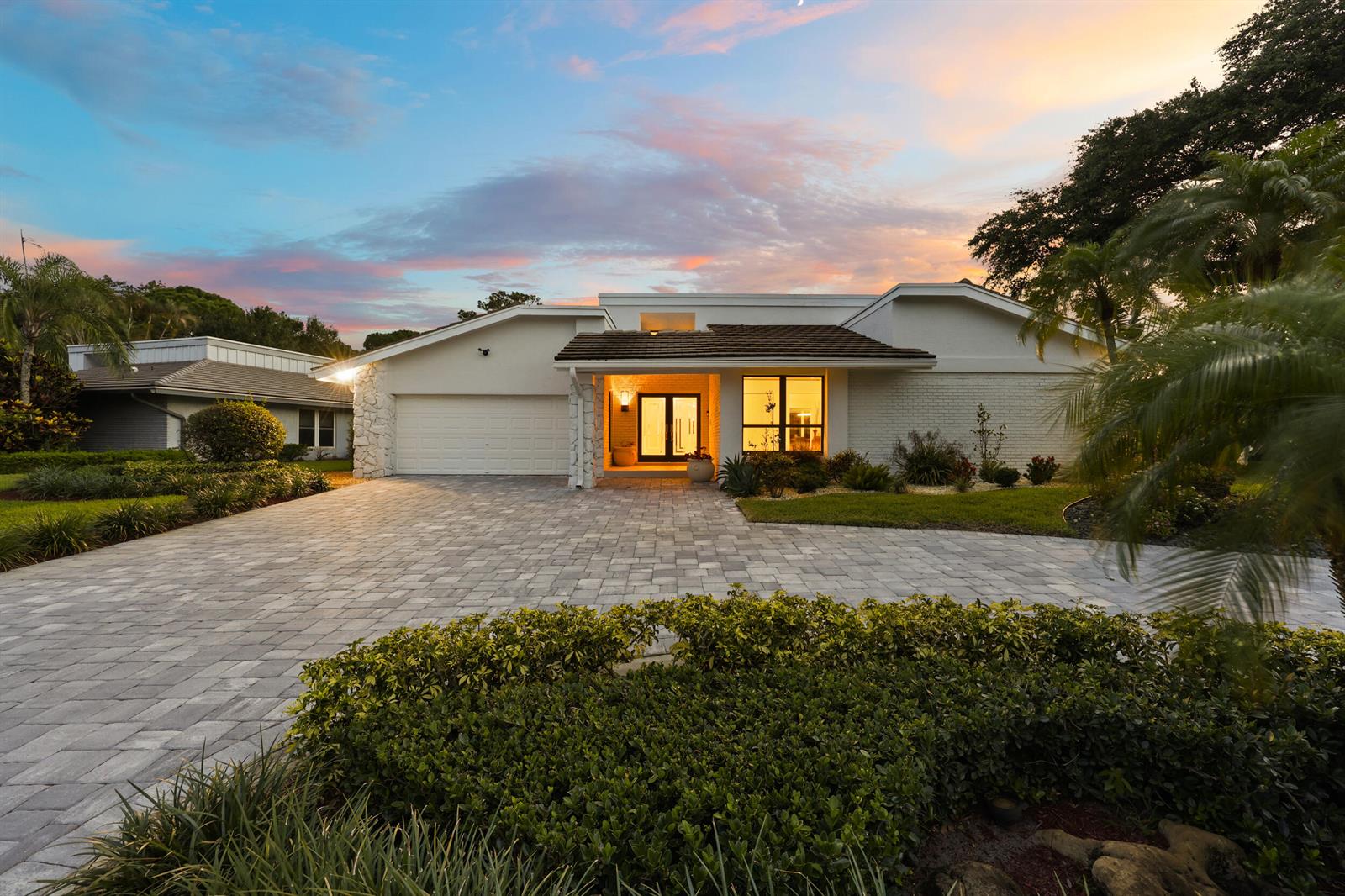 A single-story house with a paved driveway, white exterior, and a covered front entryway — 624 W Lakewoode Circle W, Delray Beach FL 33445, DELRAY BEACH, FL