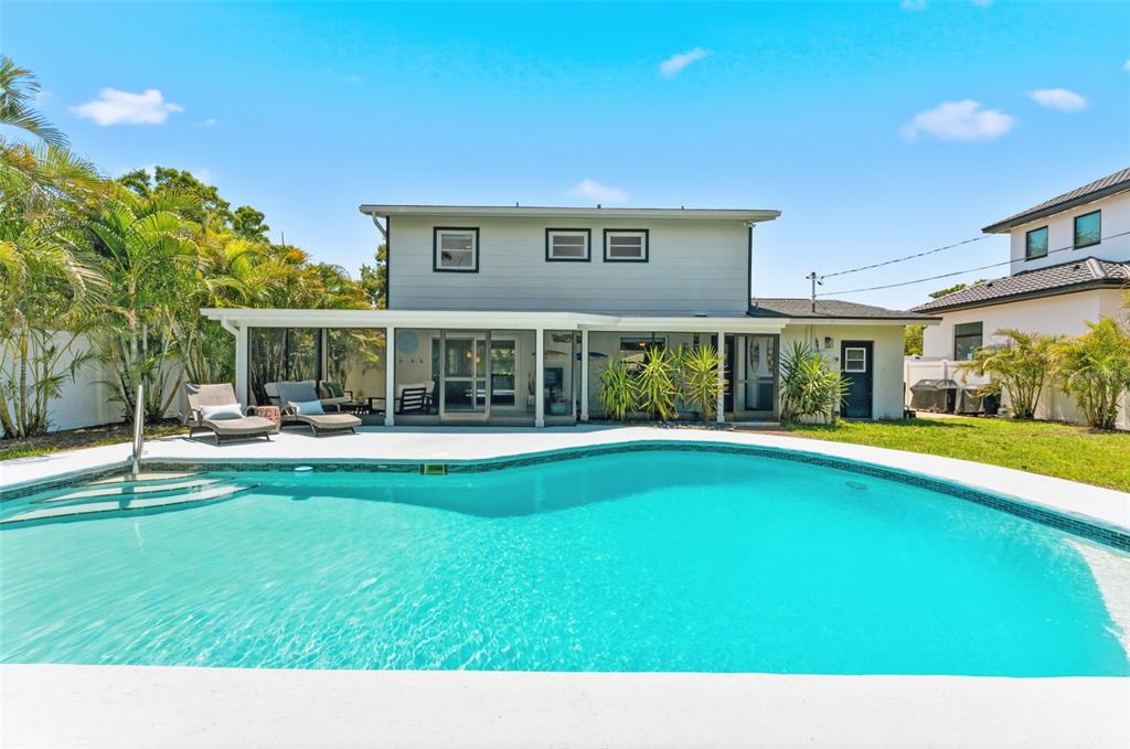 A two-story house with a screened-in patio and a swimming pool in the backyard — 2701 67TH WAY N, ST PETERSBURG, FL