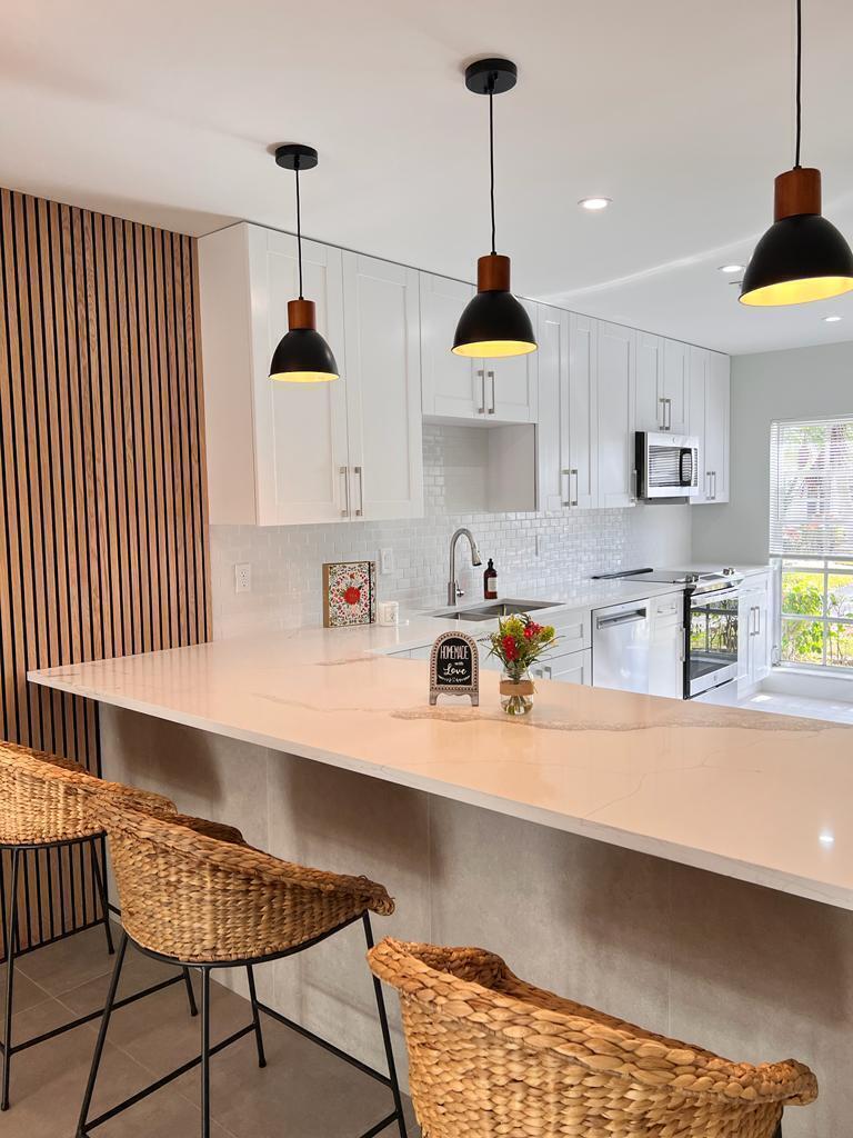 An aerial view of a community clubhouse featuring multiple swimming pools and lounge areas — 13602 Via Flora Apt C, Delray Beach FL 33484, DELRAY BEACH, FL
