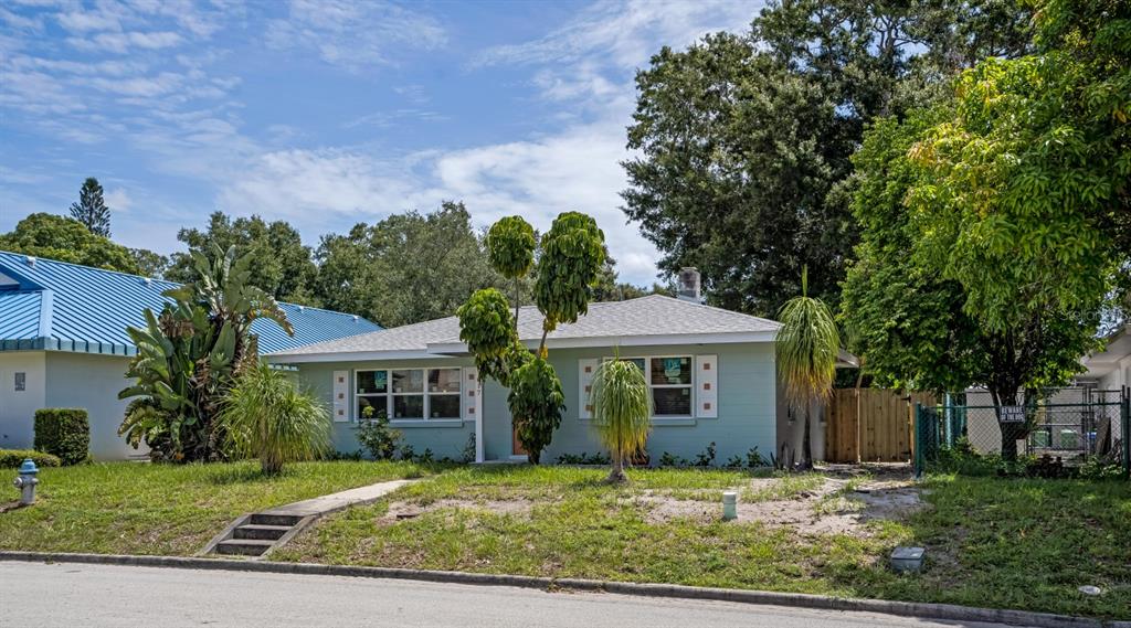 A light green single-story house with a light-colored roof and a front yard — 617 26TH STREET W, BRADENTON, FL