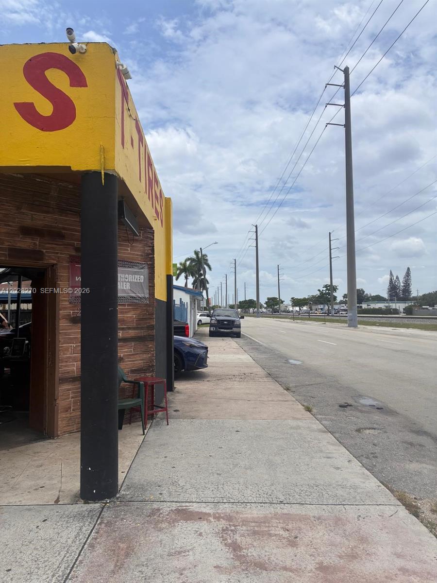 A view of a yellow building exterior with a sidewalk and a road nearby — 2337 N 21st Ave, Hollywood FL 33020, HOLLYWOOD, FL