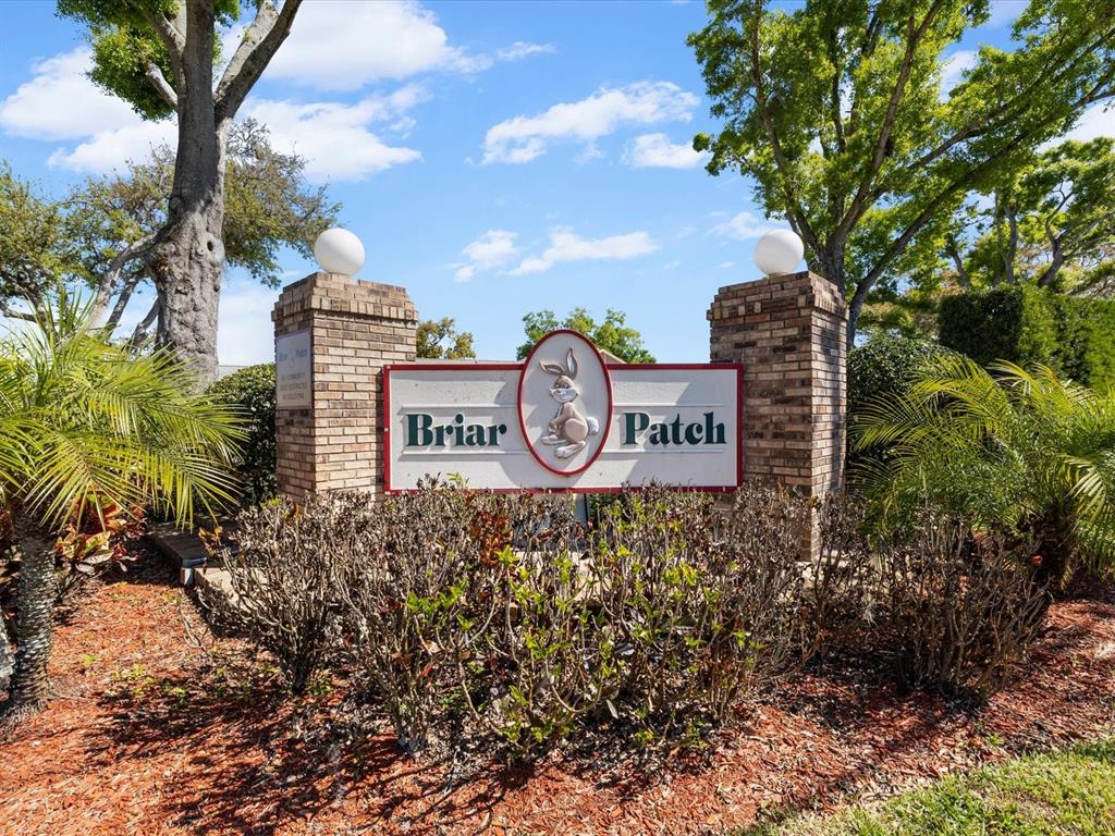 A brick monument sign with a rabbit logo marks the entrance to Briar Patch — 4505 GLEN HOLLOW, NEW PORT RICHEY, FL