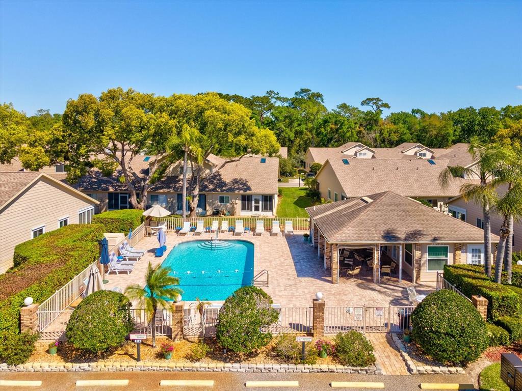 An aerial view of a community swimming pool surrounded by a patio and residential buildings — 4505 GLEN HOLLOW, NEW PORT RICHEY, FL