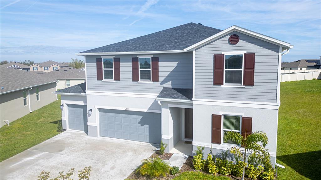 A two-story house with gray siding, a two-car garage, and brown shutters — 1531 FUJI COURT, WINTER HAVEN, FL