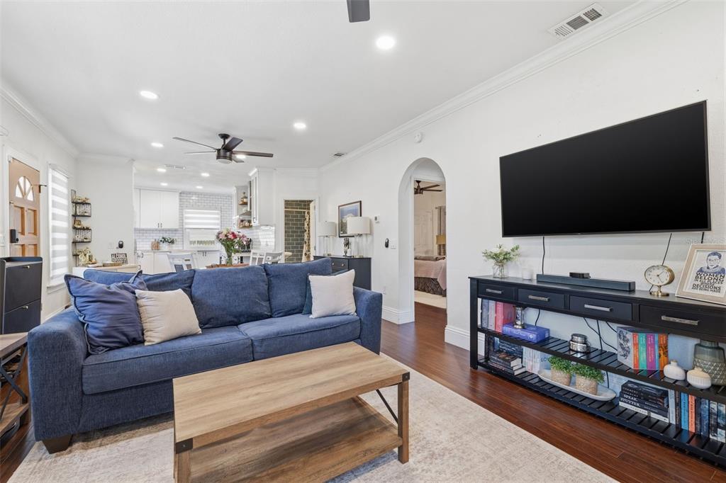 A living room features a blue sofa, a wooden coffee table, and a wall-mounted television — 2237 14TH AVENUE N, ST PETERSBURG, FL