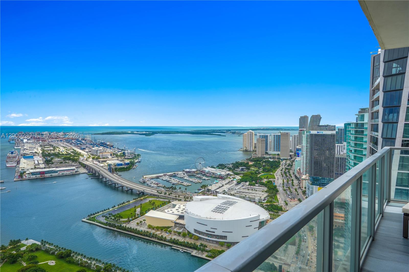 A high-angle balcony view overlooks the Miami waterfront, cruise port, and downtown city skyline — 1100 Biscayne Blvd # 6001, Miami FL 33132, MIAMI, FL