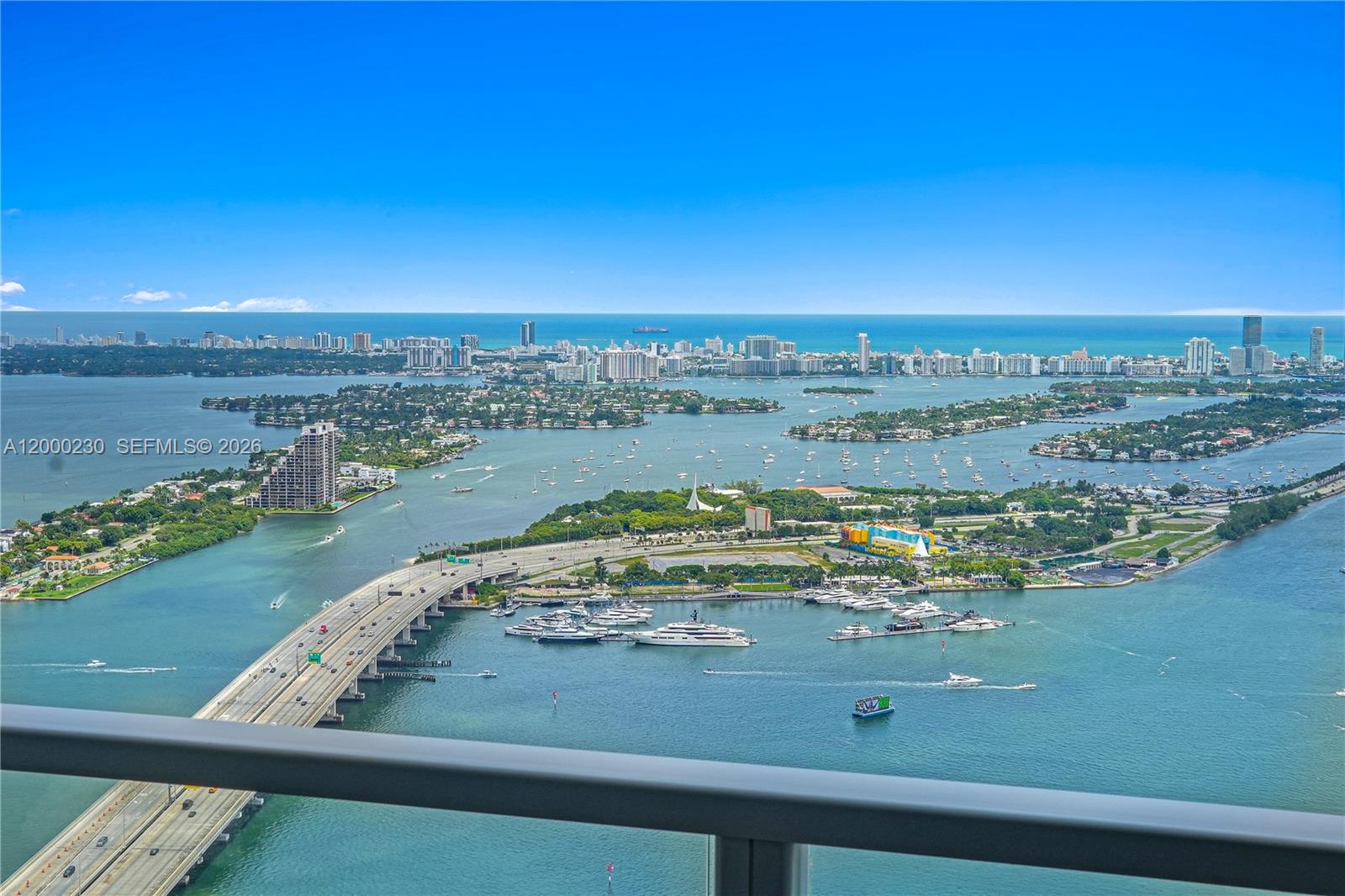 An elevated view shows a bridge, a marina, and the Miami skyline across the water — 1100 Biscayne Blvd # 6001, Miami FL 33132, MIAMI, FL