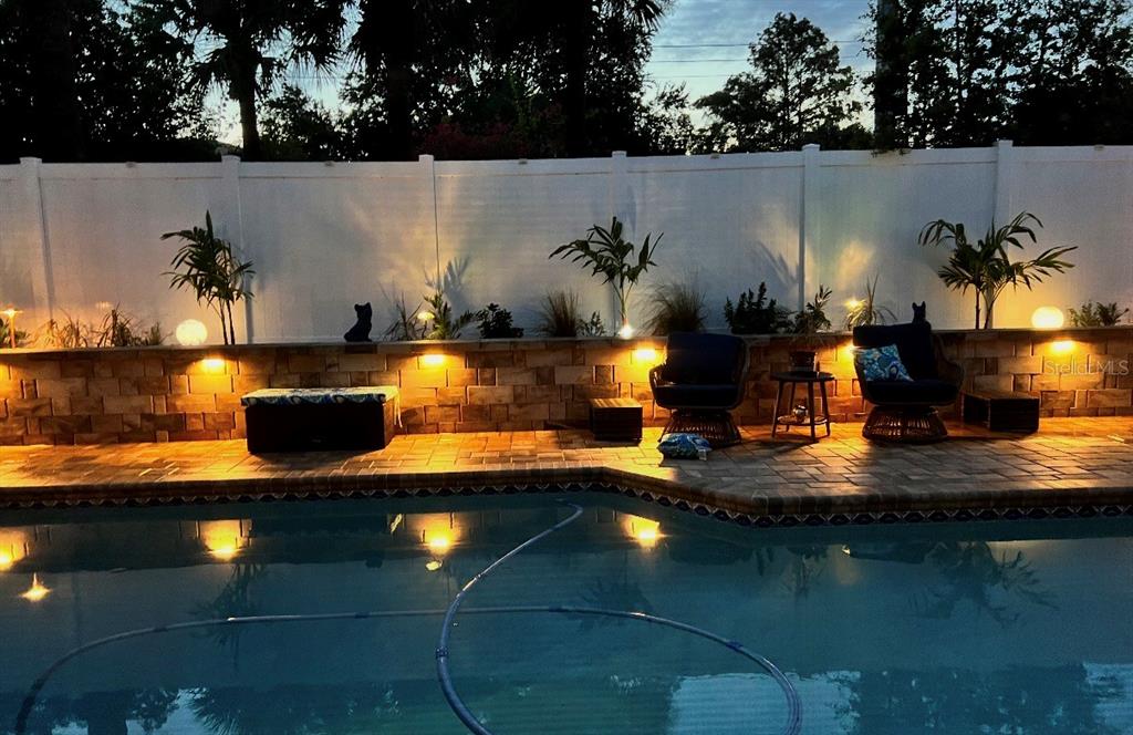 A swimming pool sits on a paved patio beside a house with a palm tree — 2680 SHADYBRANCH DRIVE, ORLANDO, FL