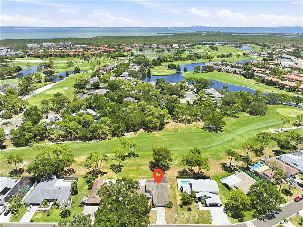 An aerial view shows a house with a red location pin overlooking a golf course — 13915 WHISPERWOOD DRIVE, CLEARWATER, FL