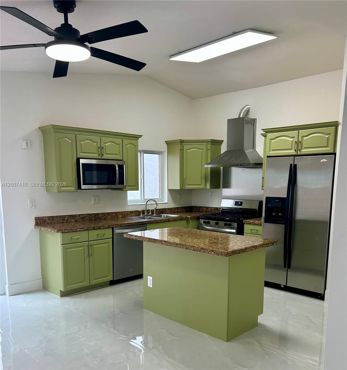 A kitchen features olive green cabinets, granite countertops, stainless steel appliances, and white tile flooring — 10058 SW 156th Ct, Miami FL 33196, MIAMI, FL