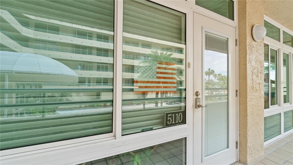 An exterior view of a building entrance with a glass door and large windows — 4565 S ATLANTIC AVENUE UNIT 5110, PORT ORANGE, FL