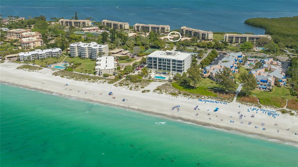 An aerial view of a beachfront resort complex with multiple buildings, pools, and sandy beaches — 4780 GULF OF MEXICO DR. VILLA 5, LONGBOAT KEY, FL