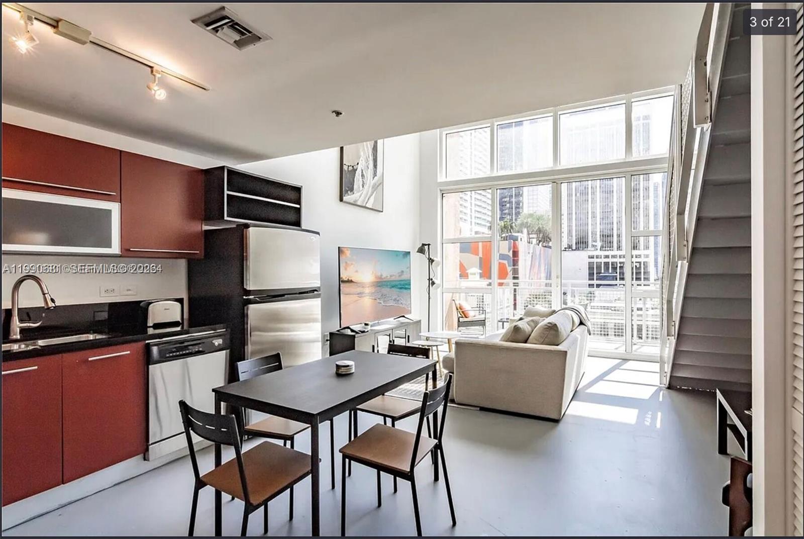 A modern apartment interior features a kitchen, dining area, and living room with floor-to-ceiling windows — 253 NE 2nd St # 617, Miami FL 33132, MIAMI, FL