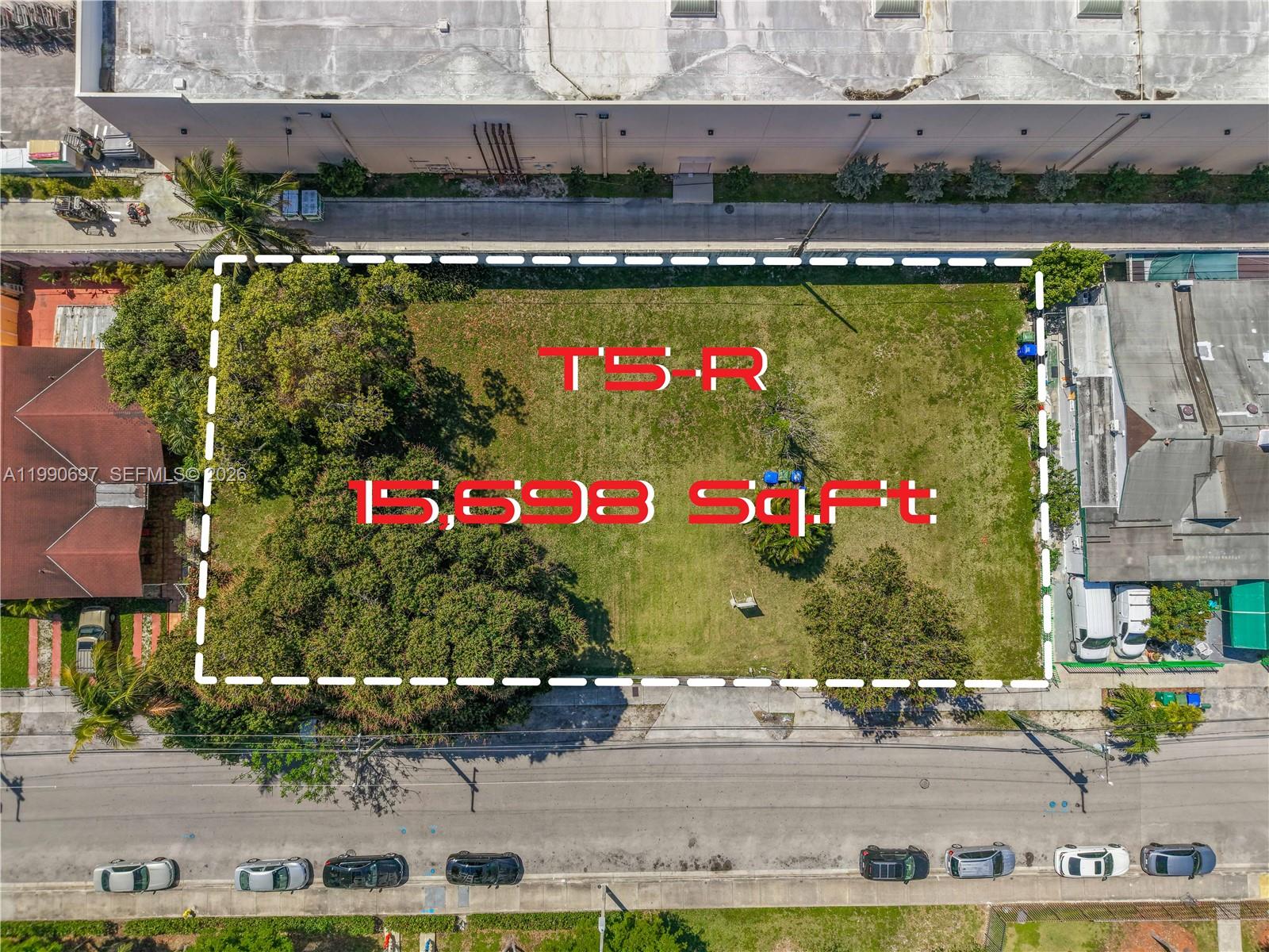 An aerial view shows a rectangular vacant lot with trees, outlined in white, beside buildings — 1000 SW 30th Ave, Miami FL 33135, MIAMI, FL