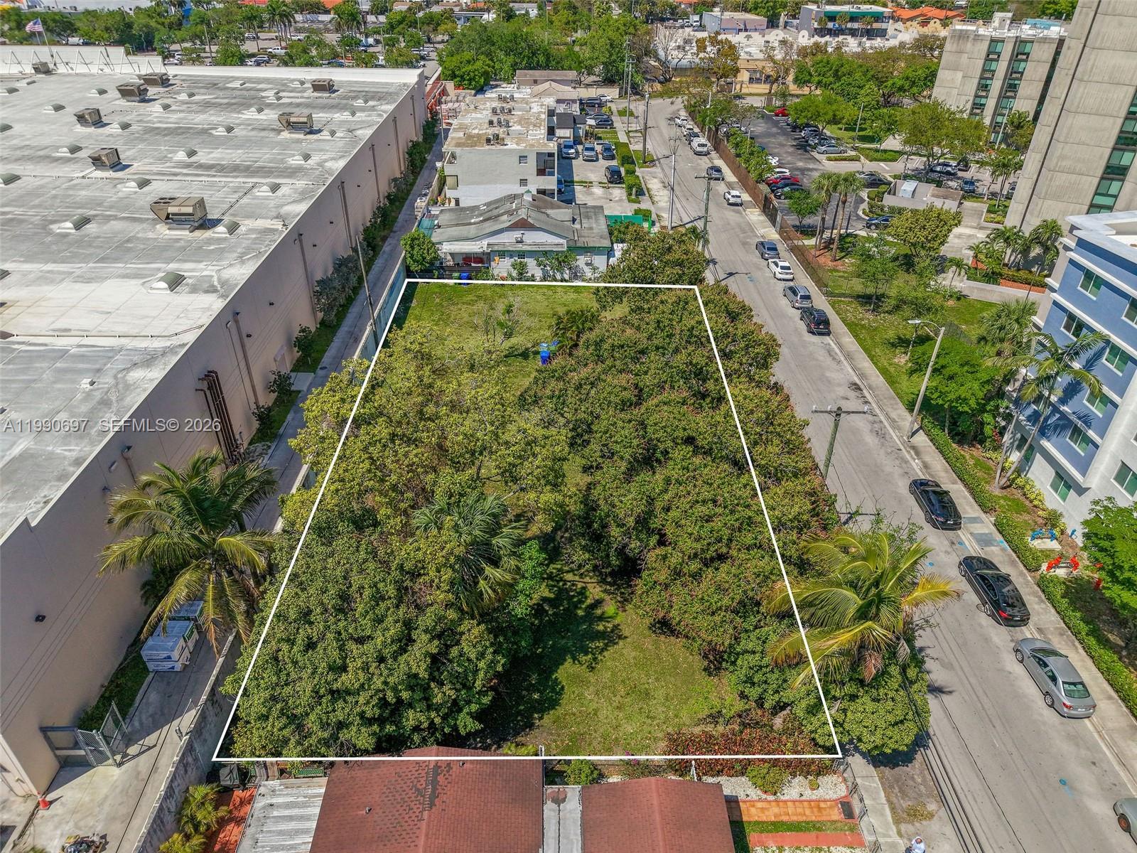 An aerial view shows a rectangular vacant lot bordered by a warehouse and a street — 1000 SW 30th Ave, Miami FL 33135, MIAMI, FL