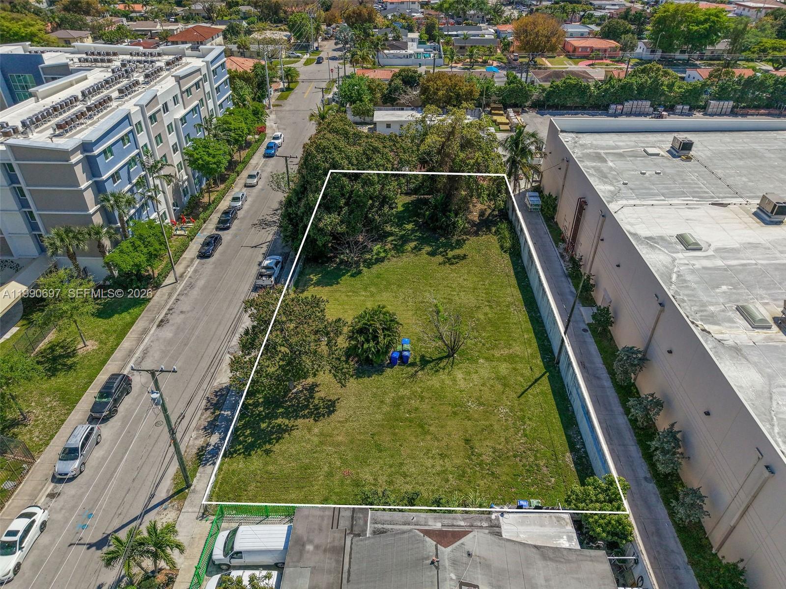 An aerial view shows a vacant rectangular lot situated between a street and a building — 1000 SW 30th Ave, Miami FL 33135, MIAMI, FL
