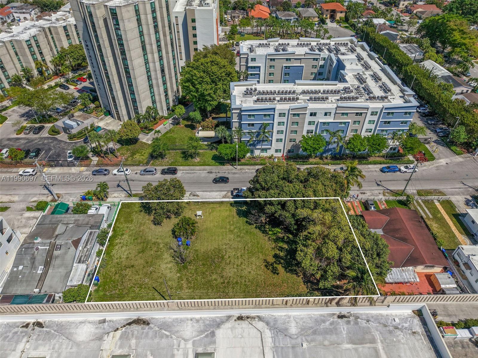 An aerial view shows a rectangular vacant lot surrounded by residential buildings and trees — 1000 SW 30th Ave, Miami FL 33135, MIAMI, FL
