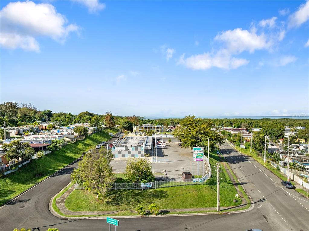 An aerial view shows a commercial building with a parking lot surrounded by green space — 308 KM 5.3, CABO ROJO, PR