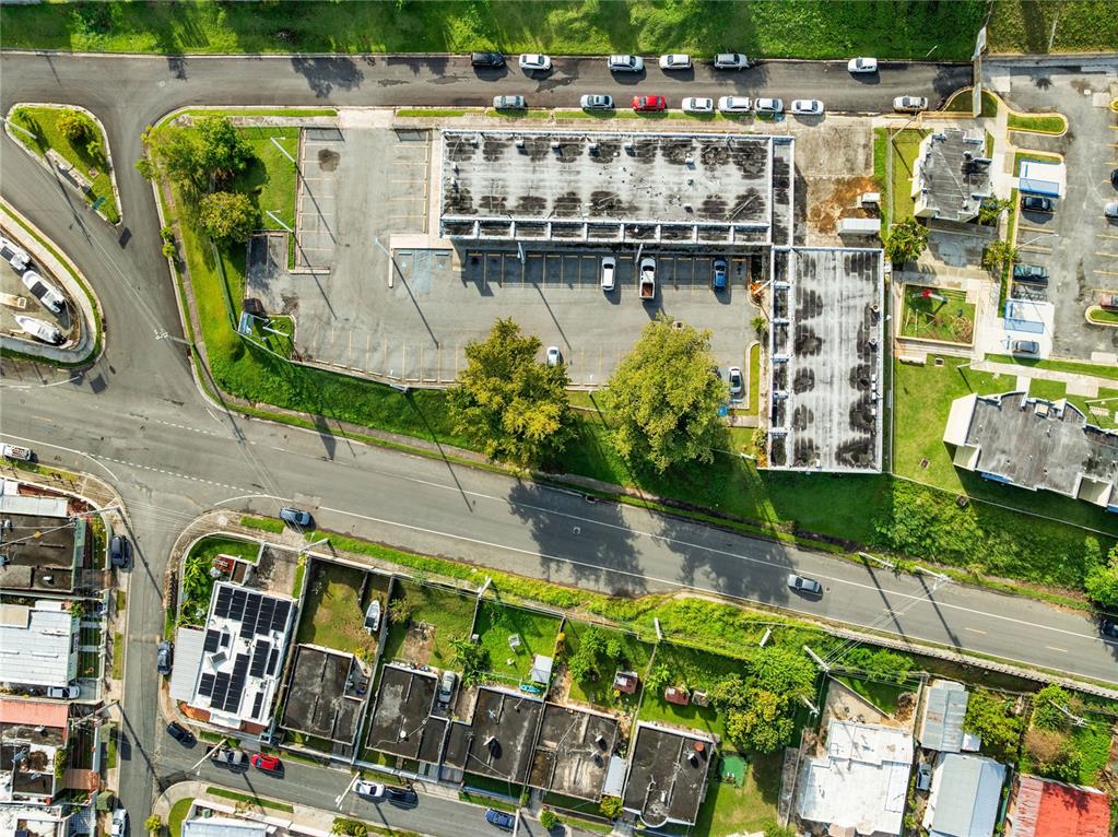 An aerial view shows a commercial building with a parking lot and surrounding residential streets — 308 KM 5.3, CABO ROJO, PR