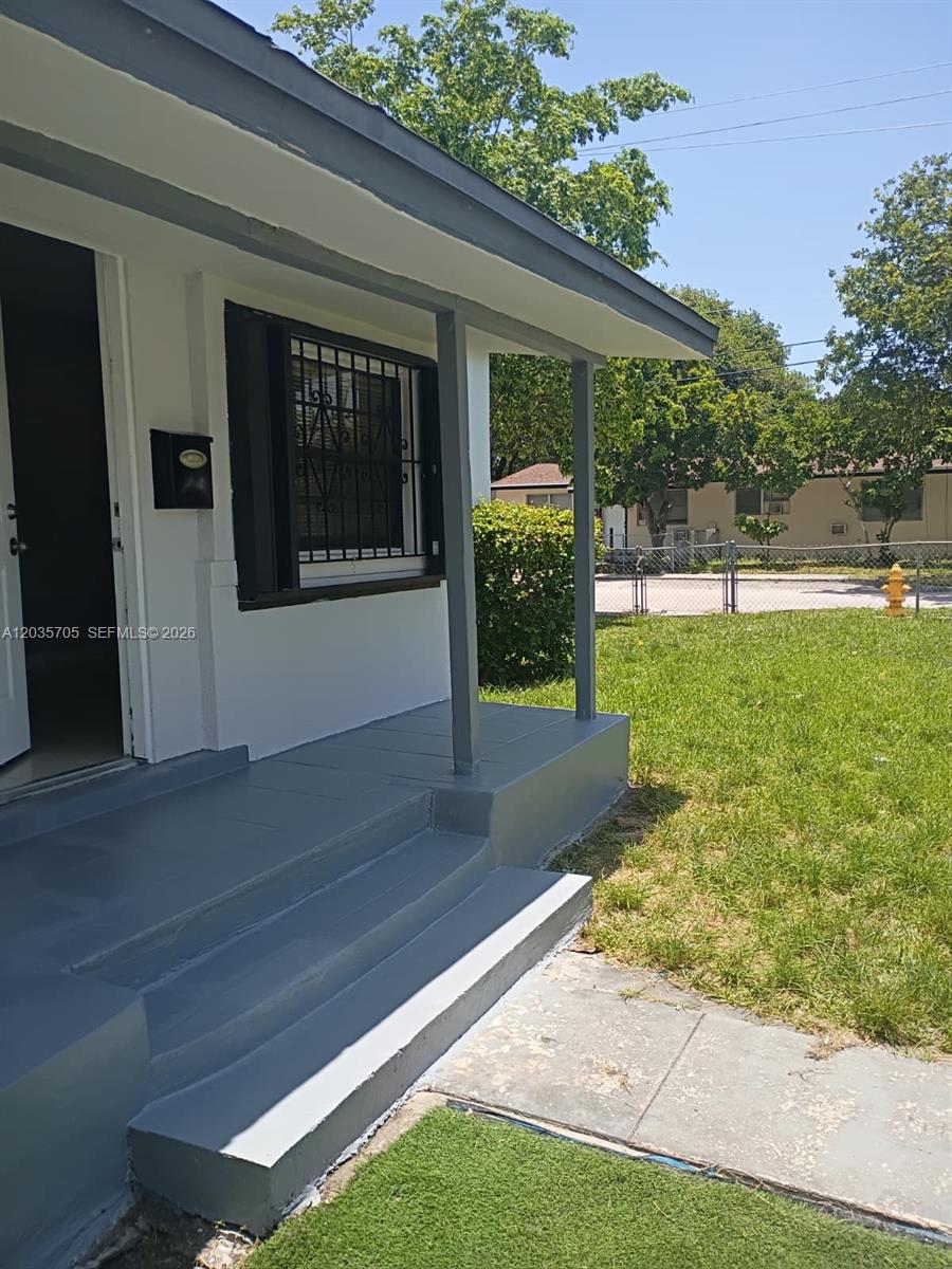 A painted concrete porch with steps leads to the front entrance of a house — 1101 NW 55th Ter, Miami FL 33127, MIAMI, FL