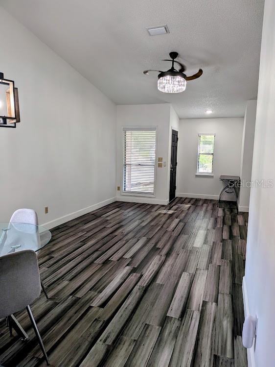 A dining area with wood-look tile flooring, a ceiling fan, and two windows — 1021 LOVE LANE UNIT 39, APOPKA, FL