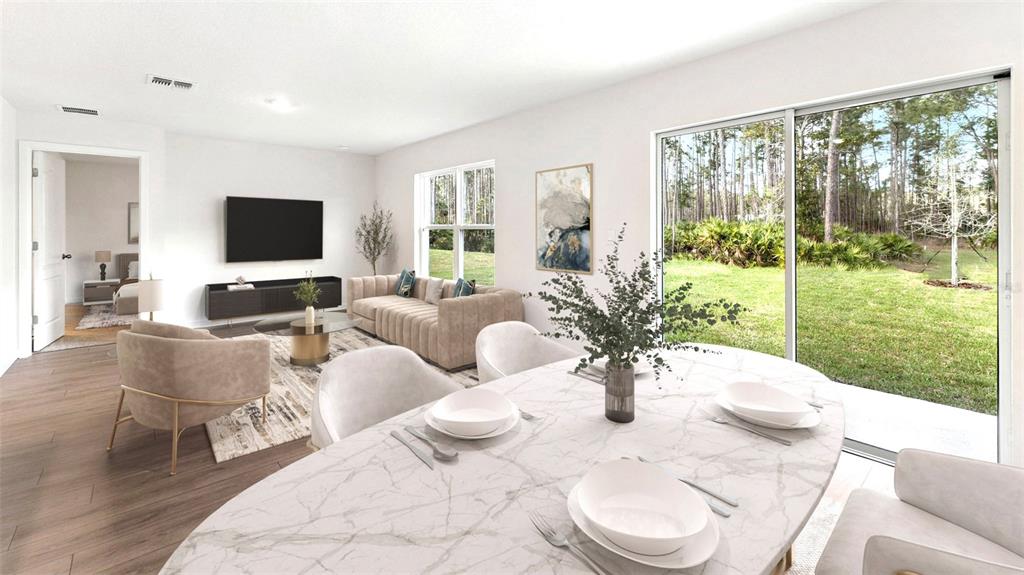 This rendering shows an open-concept living and dining area with a view of the backyard — 1476 MORNING WALK DRIVE, ORMOND BEACH, FL