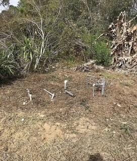 Exposed plumbing pipes and a metal frame stand on a patch of cleared, dry land — 9320 CANAL ROAD, HAINES CITY, FL