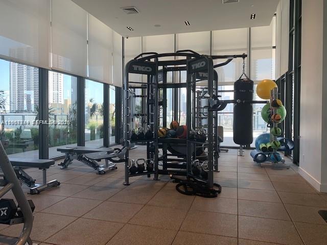 A modern gym features a TKO multi-station exercise machine, a punching bag, and floor-to-ceiling windows — 1600 NE 1st Ave # 3319, Miami FL 33132, MIAMI, FL