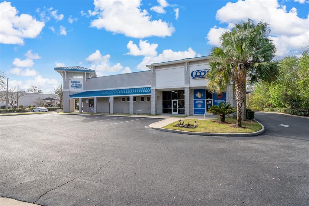 A commercial building with a blue metal roof and a palm tree in the parking lot — 14451 W NEWBERRY ROAD, NEWBERRY, FL