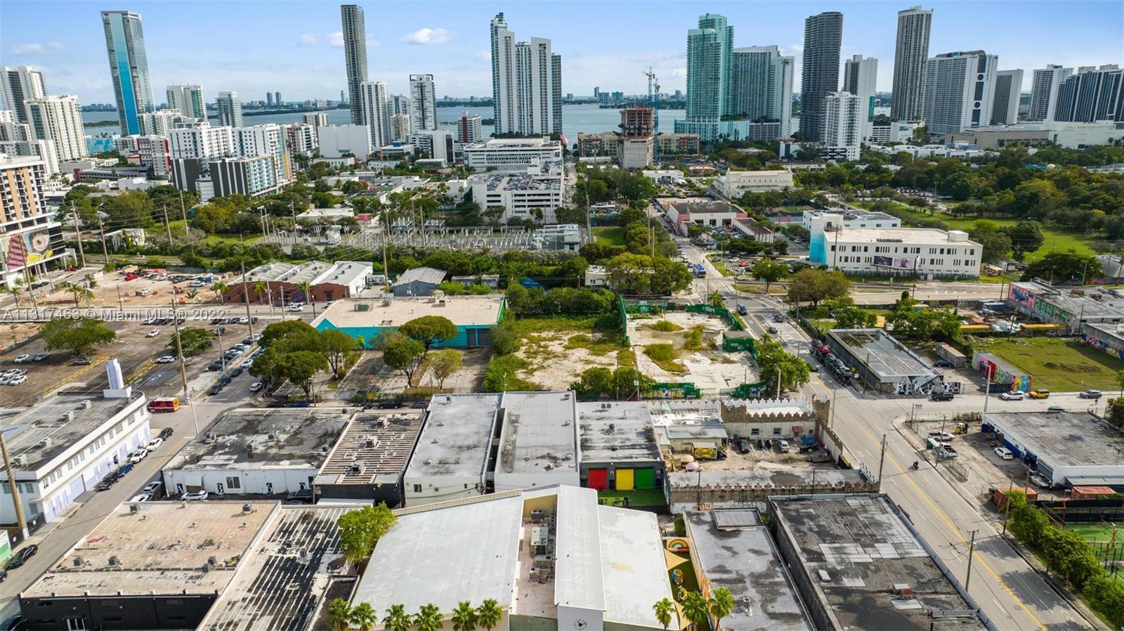 An aerial view shows a vacant lot surrounded by urban buildings and city skyscrapers — 2010,2014,2020 NW Miami Ct, Miami FL 33127, MIAMI, FL