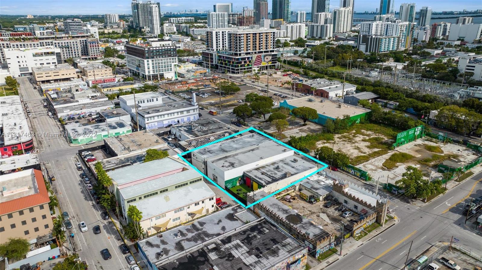 An aerial view shows a rectangular commercial building highlighted in blue within an urban neighborhood — 2010,2014,2020 NW Miami Ct, Miami FL 33127, MIAMI, FL