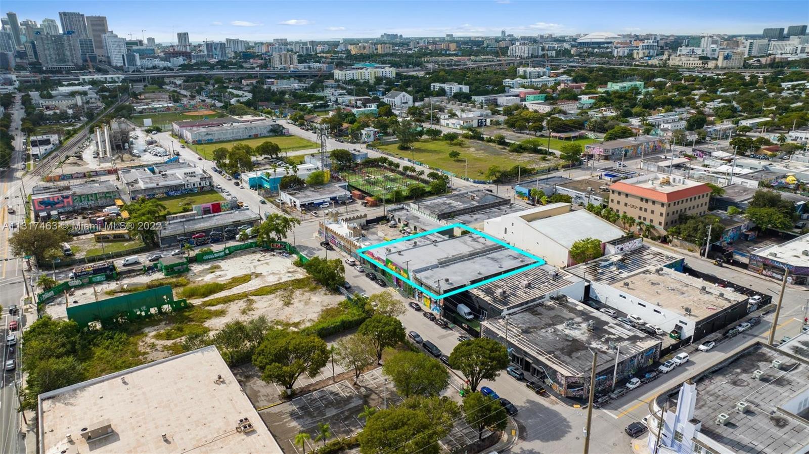 An aerial view shows a flat-roofed commercial building highlighted in blue within an urban neighborhood — 2010,2014,2020 NW Miami Ct, Miami FL 33127, MIAMI, FL