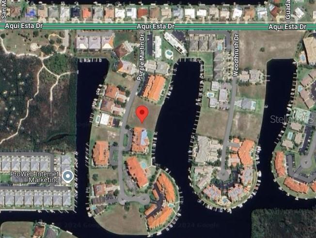 This aerial map shows a vacant residential lot located between two waterfront housing developments — 3242 PURPLE MARTIN DRIVE, PUNTA GORDA, FL