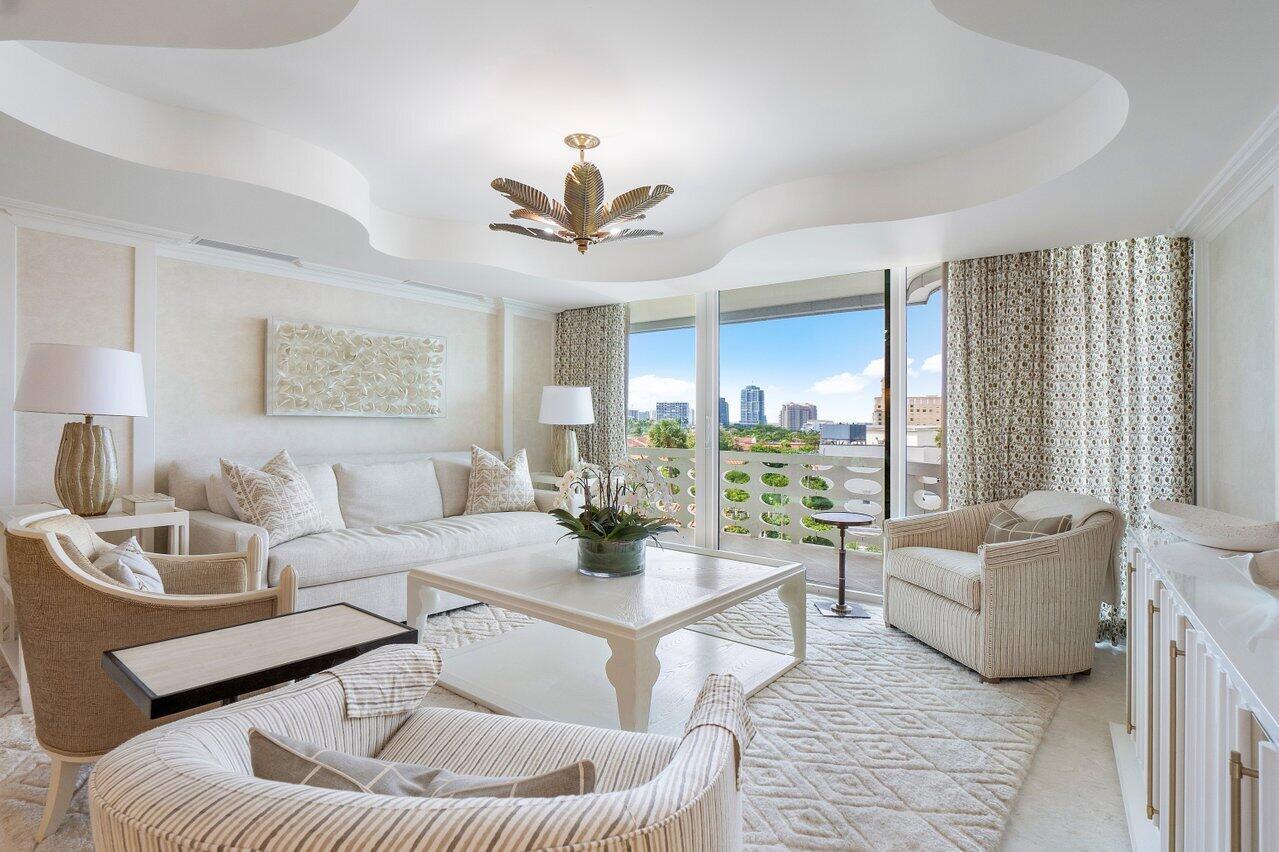 A bright living room features a white sofa, patterned armchairs, and a balcony with city views — 130 Sunrise Avenue # 616, Palm Beach FL 33480, PALM BEACH, FL