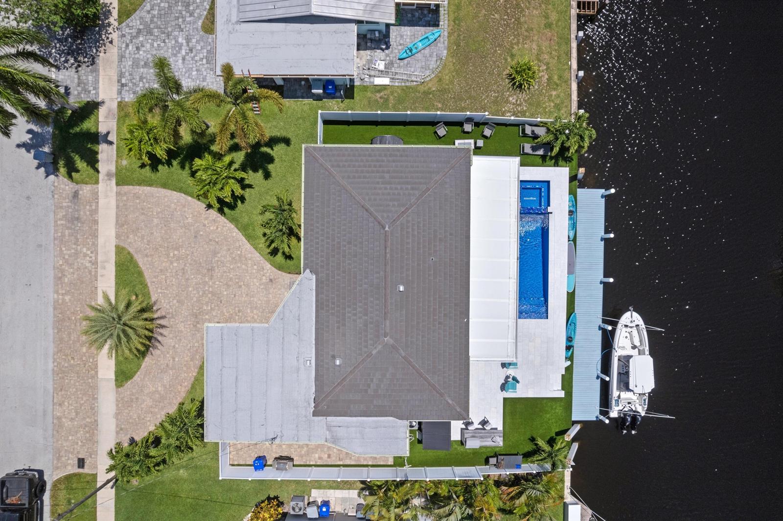 An aerial view shows a house with a pool, dock, and boat on a canal — 160 SE 12th Court, Pompano Beach FL 33060, POMPANO BEACH, FL
