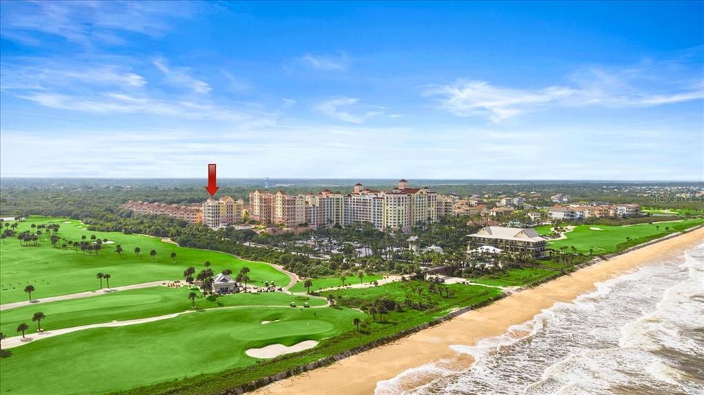 An aerial view shows a large beachfront resort complex adjacent to a green golf course — 200 OCEAN CREST DRIVE UNIT 646, PALM COAST, FL