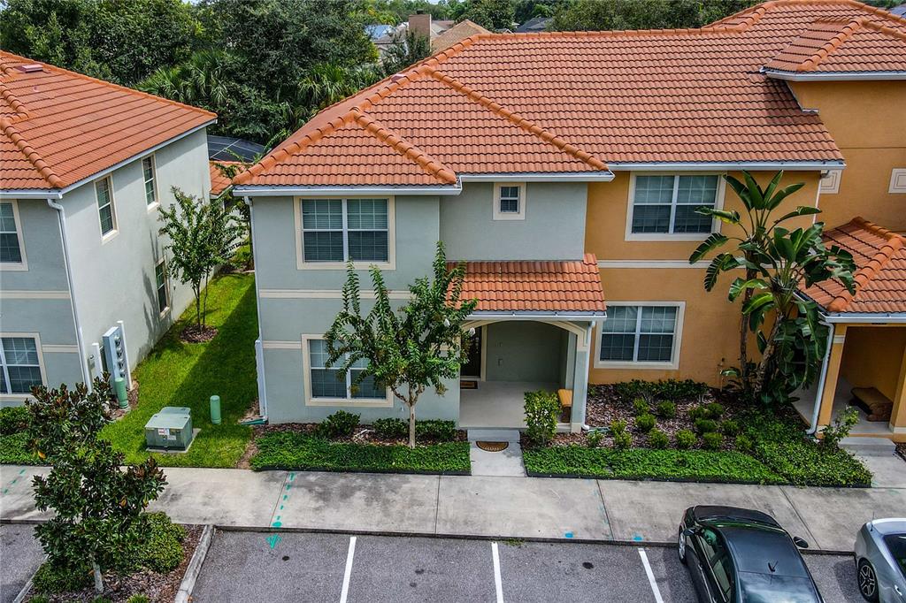 An aerial view shows the exterior of a two-story townhouse with a tiled roof — 2963 BANANA PALM DRIVE, KISSIMMEE, FL