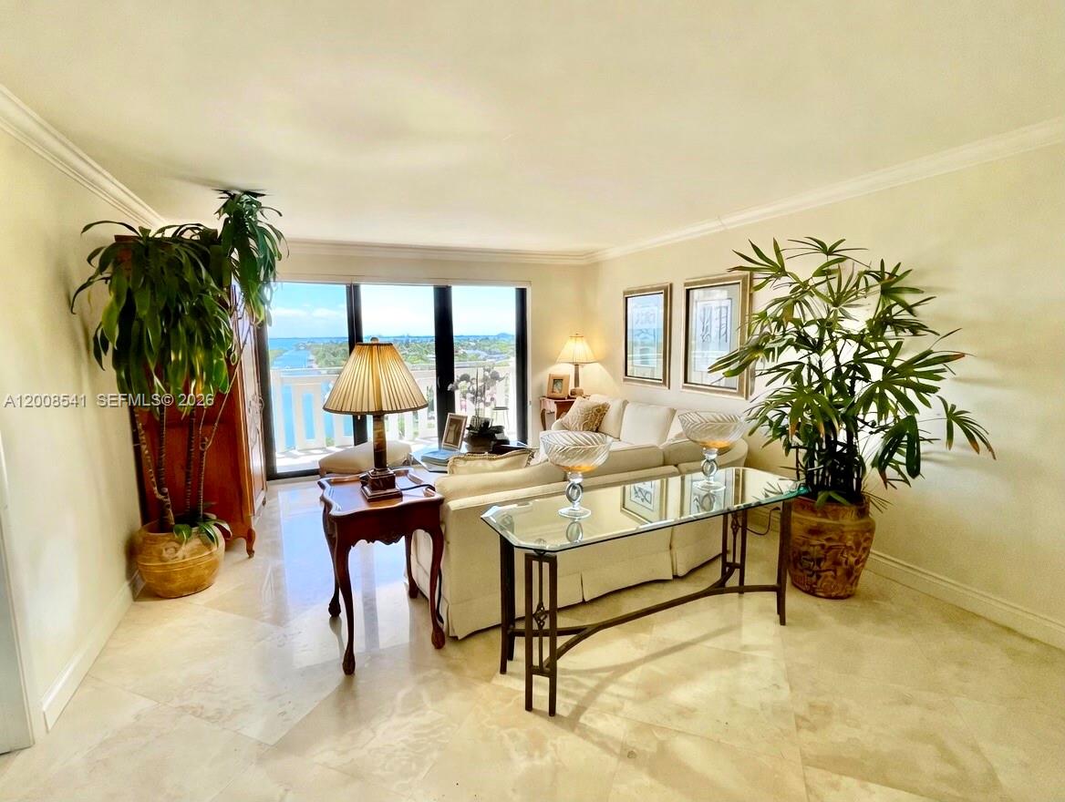 A living room features light tile floors, a glass console table, and a balcony view — 1121 Crandon Blvd # D903, Key Biscayne FL 33149, KEY BISCAYNE, FL