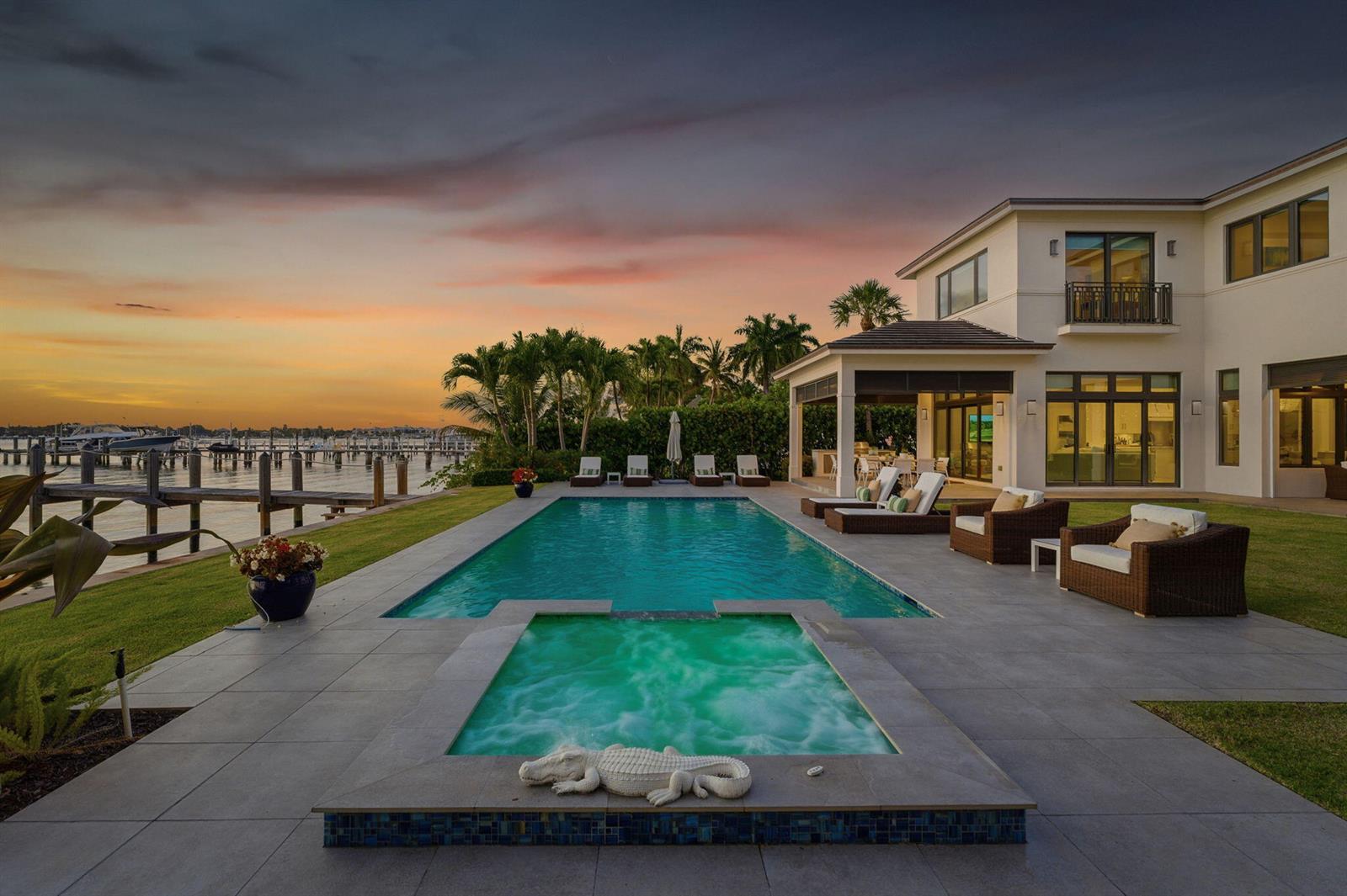 A modern two-story house with a pool, hot tub, and patio overlooking a boat dock — 825 W Oyster Lane, Lantana FL 33462, LANTANA, FL
