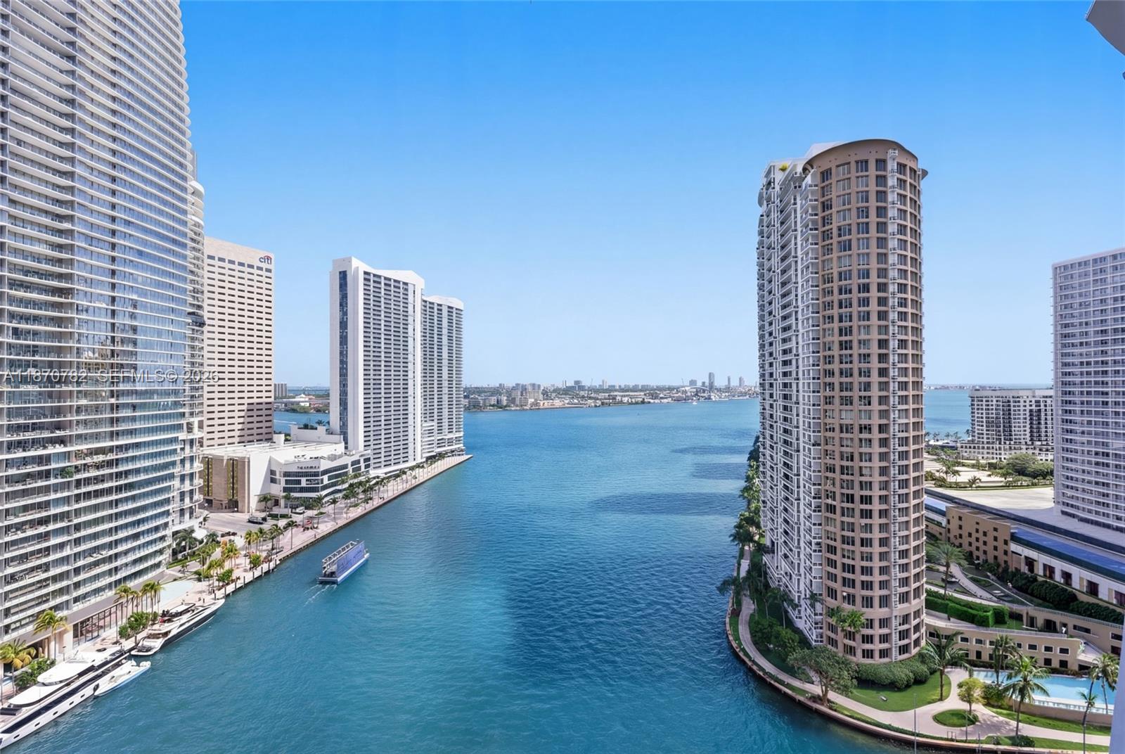An elevated view of a waterway flanked by tall residential skyscrapers under a clear sky — 465 Brickell Ave # 2002, Miami FL 33131, MIAMI, FL