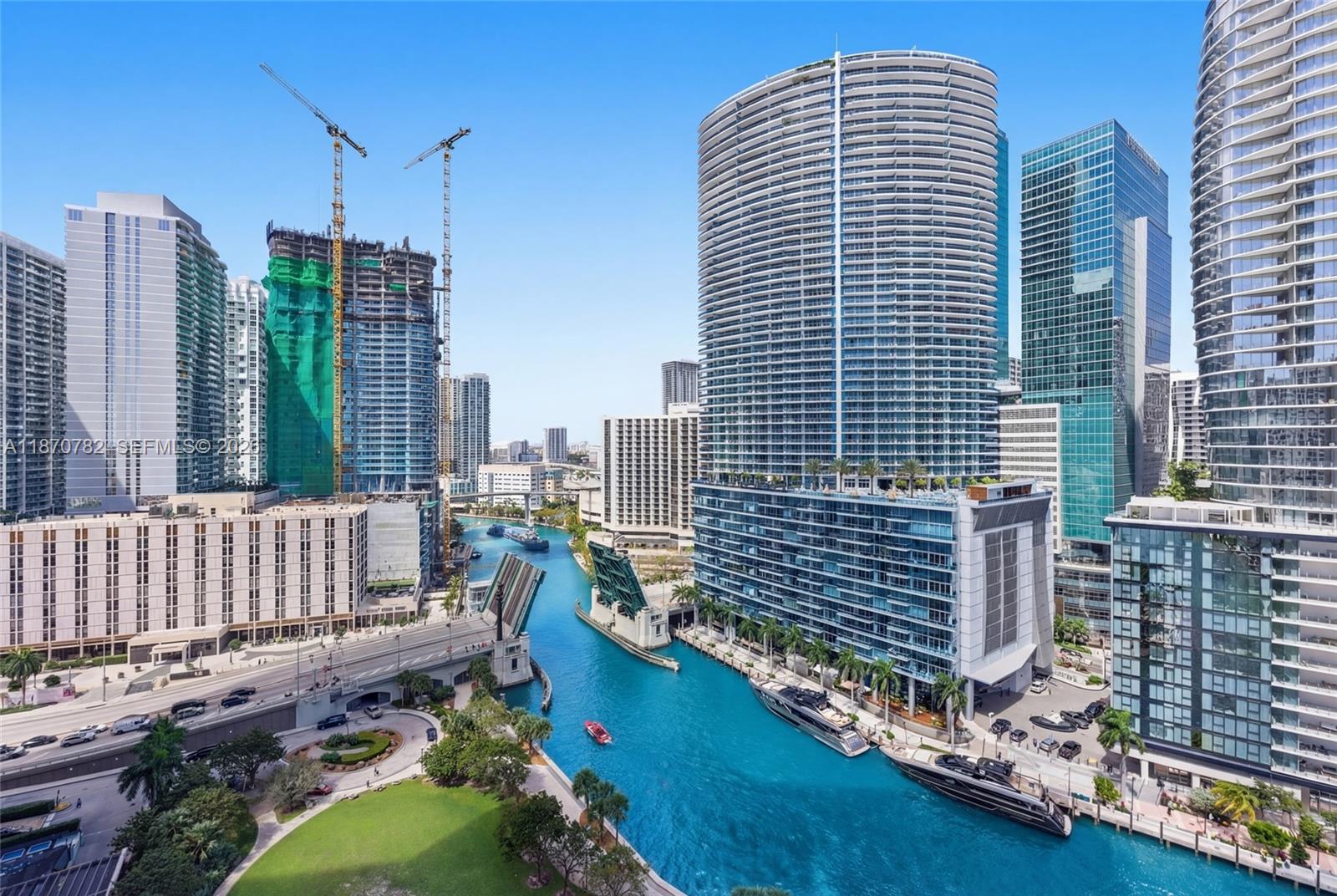 An elevated view of a city canal with a drawbridge, yachts, and surrounding high-rise buildings — 465 Brickell Ave # 2002, Miami FL 33131, MIAMI, FL