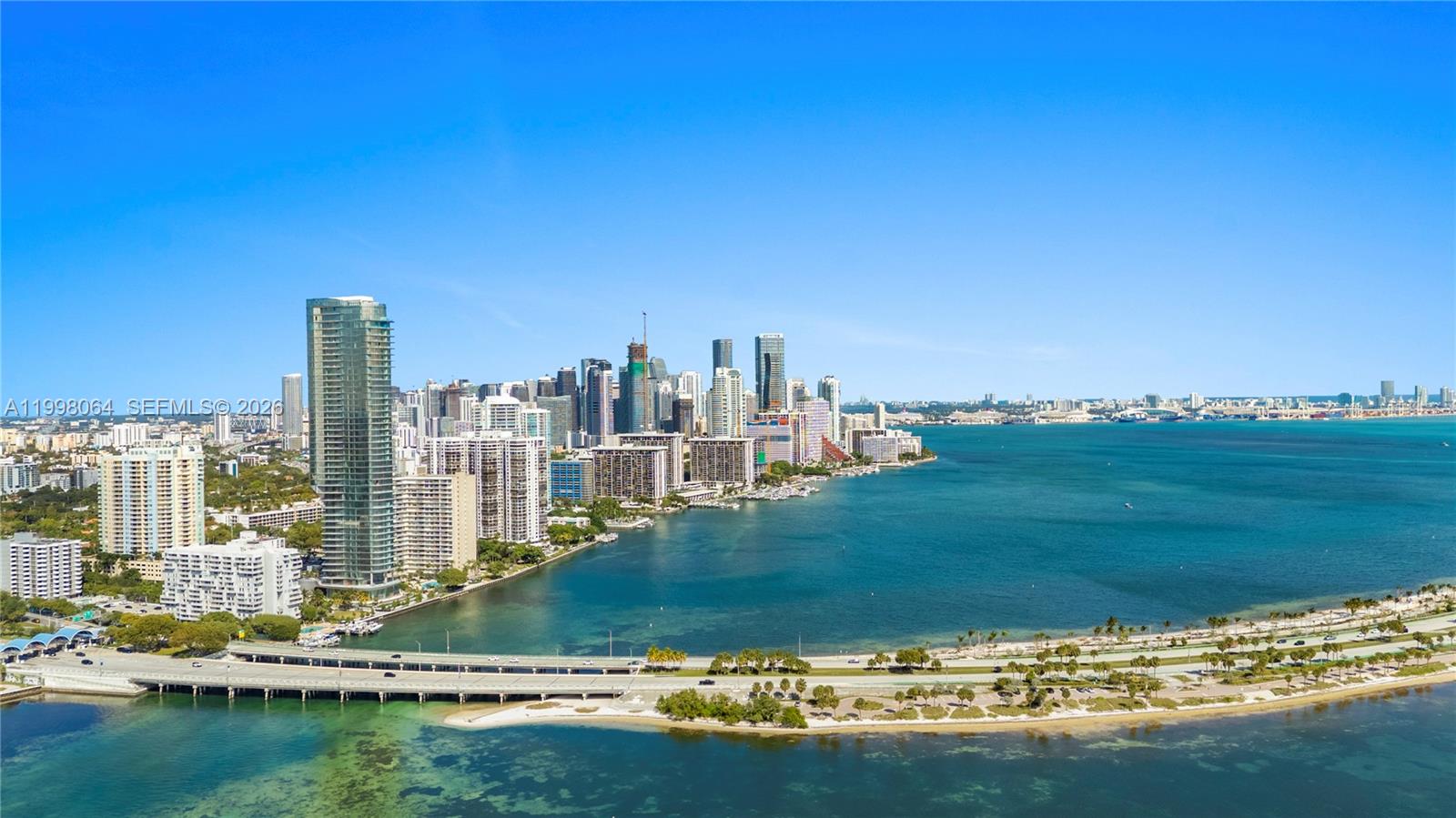 An aerial view shows a coastal city skyline with high-rise buildings and a bridge — 175 SE 25 Rd # 2003, Miami FL 33129, MIAMI, FL