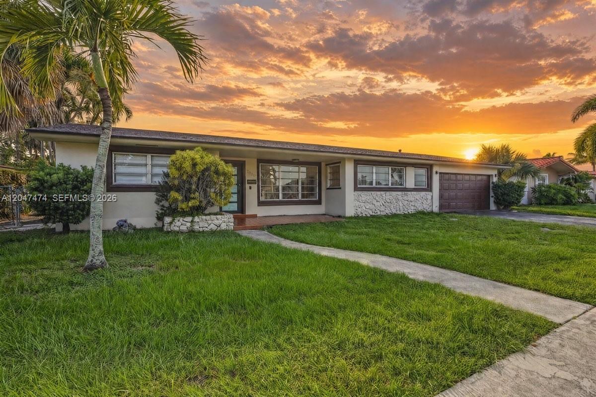 A single-story house with a stone facade, a brown garage door, and a sunset sky — 7850 W 16th Ave, Hialeah FL 33014, HIALEAH, FL