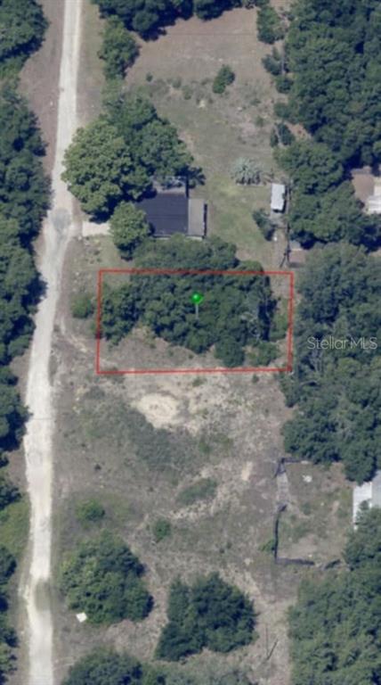 This aerial view shows a rectangular plot of land outlined in red near a dirt road — 2808 VAN BUREN STREET W, INVERNESS, FL