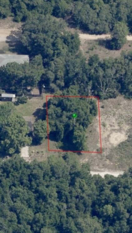 An aerial view shows a rectangular plot of land outlined in red amidst wooded surroundings — 2808 VAN BUREN STREET W, INVERNESS, FL