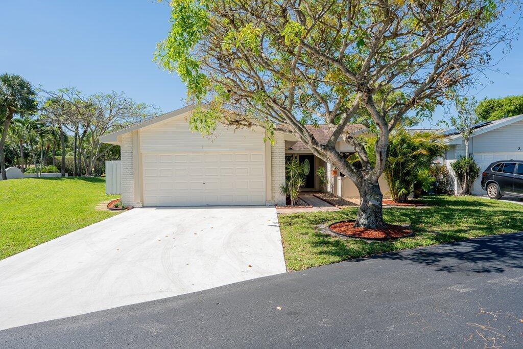 A single-story house with a white garage, a large tree, and a paved driveway — 1 Afton Place, Boynton Beach FL 33426, BOYNTON BEACH, FL