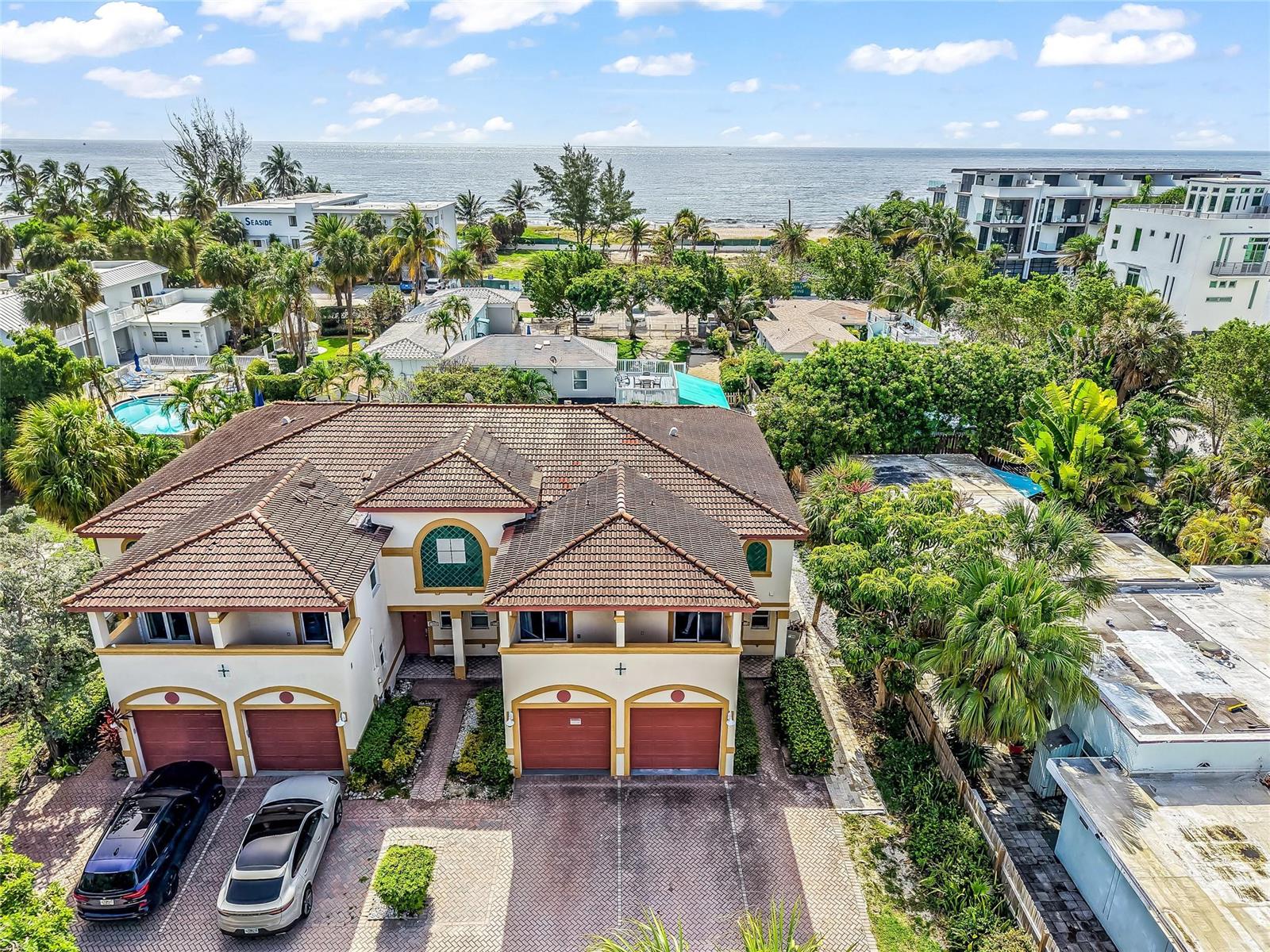 An aerial view shows a two-story residential building with four garage doors and a tiled roof — 512 S Ocean Boulevard, Pompano Beach FL 33062, POMPANO BEACH, FL