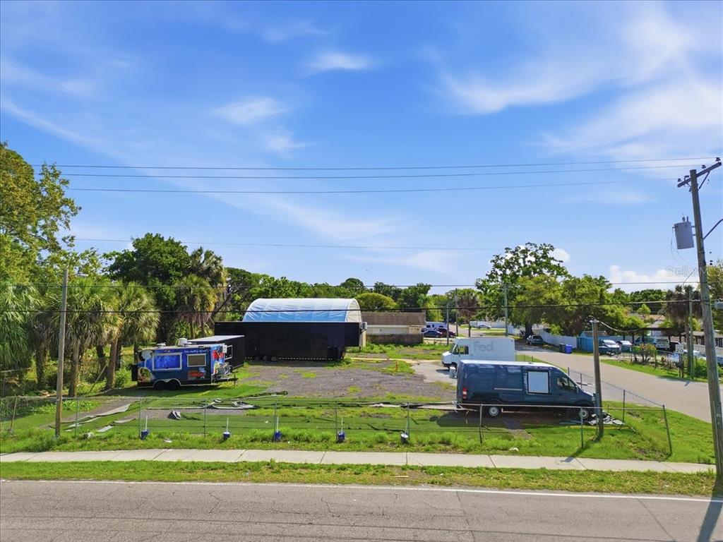 An outdoor lot features a food truck, a large trailer, and a van — 7511 WINCHESTER DRIVE, TAMPA, FL